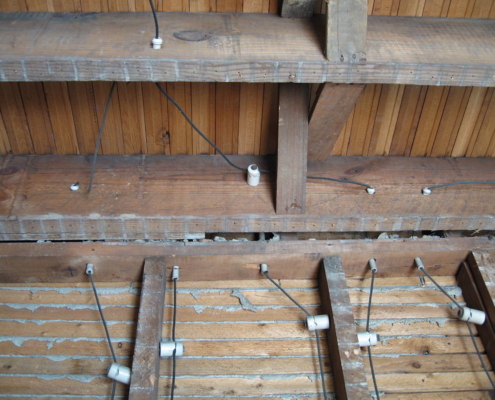 Knob-and-tube wiring visible in exposed ceiling framing